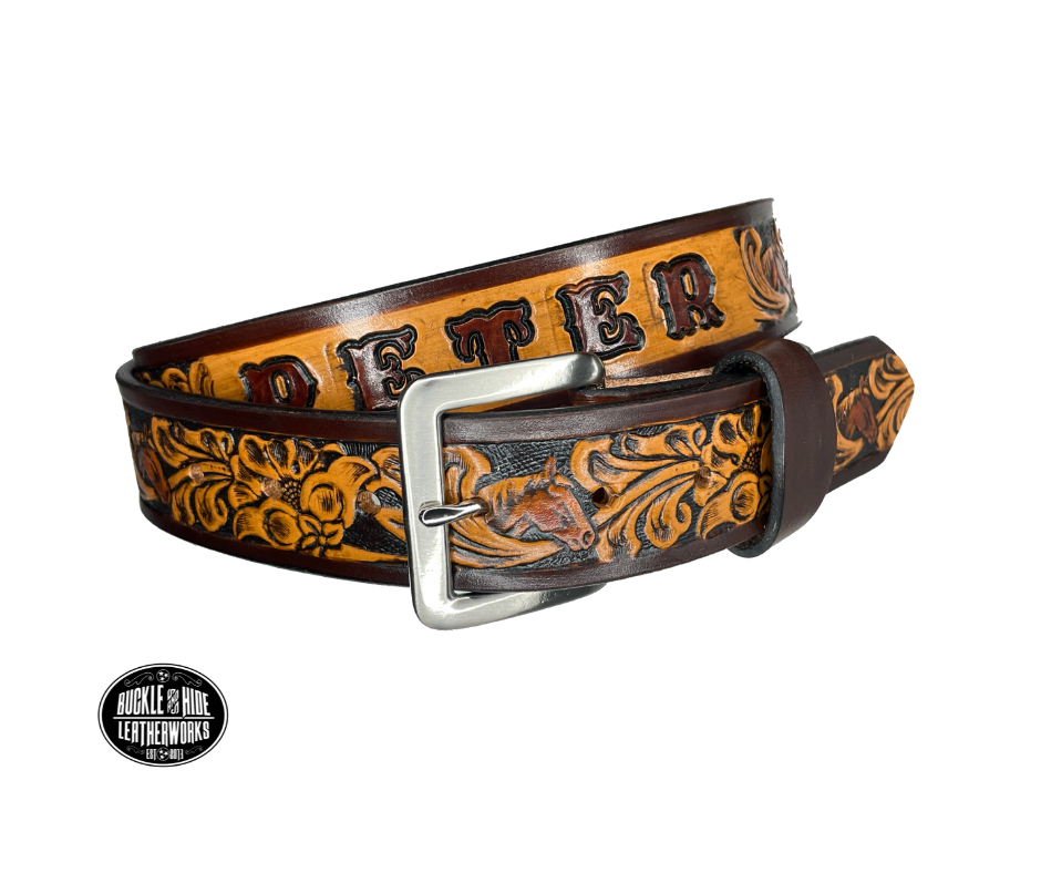 Vegetable tanned cowhide approx. 1/8"thick. Width 1 1/2" and includes Antique Nickle plated Solid Brass buckle Hand dyed BACKGROUND and finished in a TRI TONE FINISH, a multistep process which is where the DELUXE name comes from. Smooth hand burnished painted edges Choose with or without name, if without name, design will cover entire length of belt For name Type name desired on belt in "Type Name Here" section, no more than 8 letters maximum  Made in our Smyrna, TN, USA shop