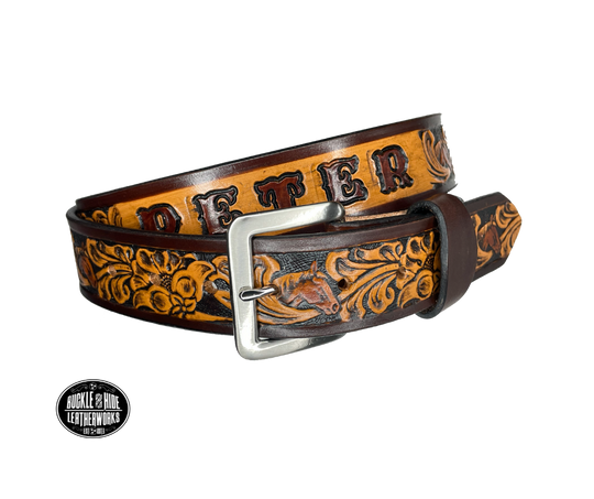Vegetable tanned cowhide approx. 1/8"thick. Width 1 1/2" and includes Antique Nickle plated Solid Brass buckle Hand dyed BACKGROUND and finished in a TRI TONE FINISH, a multistep process which is where the DELUXE name comes from. Smooth hand burnished painted edges Choose with or without name, if without name, design will cover entire length of belt For name Type name desired on belt in "Type Name Here" section, no more than 8 letters maximum  Made in our Smyrna, TN, USA shop