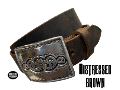 Rectangular antique silver belt buckle with western style tooling, size approx. 3" wide by 2 1/2" tall. Belt is handmade from a single strip of leather in our shop. Belt colors available are distressed brown, black, and dark brown. Buckle snaps in place for easy changing if desired.﻿ CHOOSE ONE BELT STRIP COLOR! Available online and at our shop just outside Nashville in Smyrna, TN. Distressed brown belt.