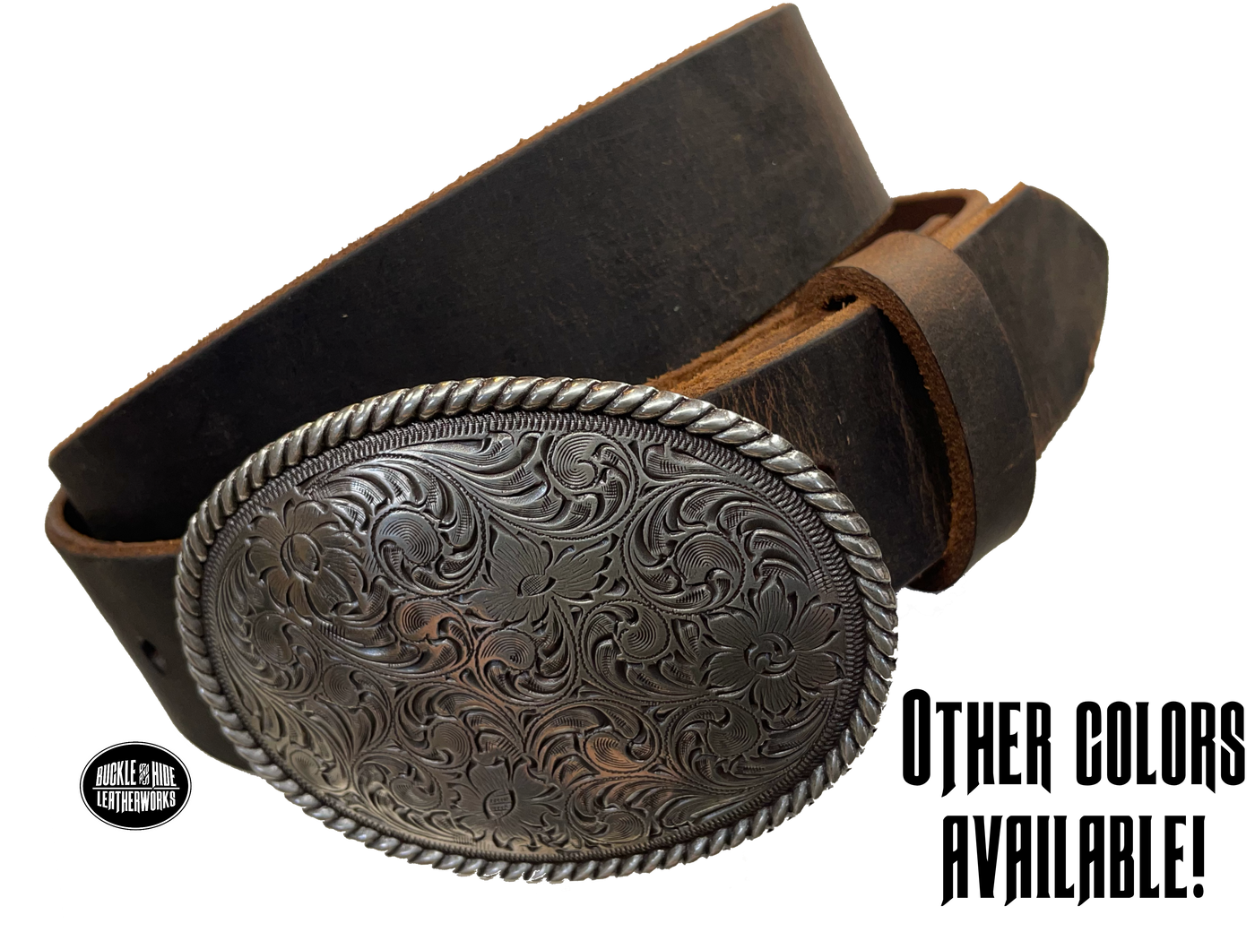 This oval shaped buckle by Nocona has a rope design around the border. It is chrome colored with scroll design etched appearance on surface.  Measures 2 3/4" tall by 3 3/4" wide and fits belts up to 1 1/2" wide. Buckle is made in Taiwan. Belt is a solid strip of leather and made in our shop in Smyrna, TN, just outside Nashville. It is 1 1/2" wide and available in sizes 34"-44" and colors distressed brown, black, and dark brown. ﻿It is available for purchase in our retail shop and online store. Main photo.