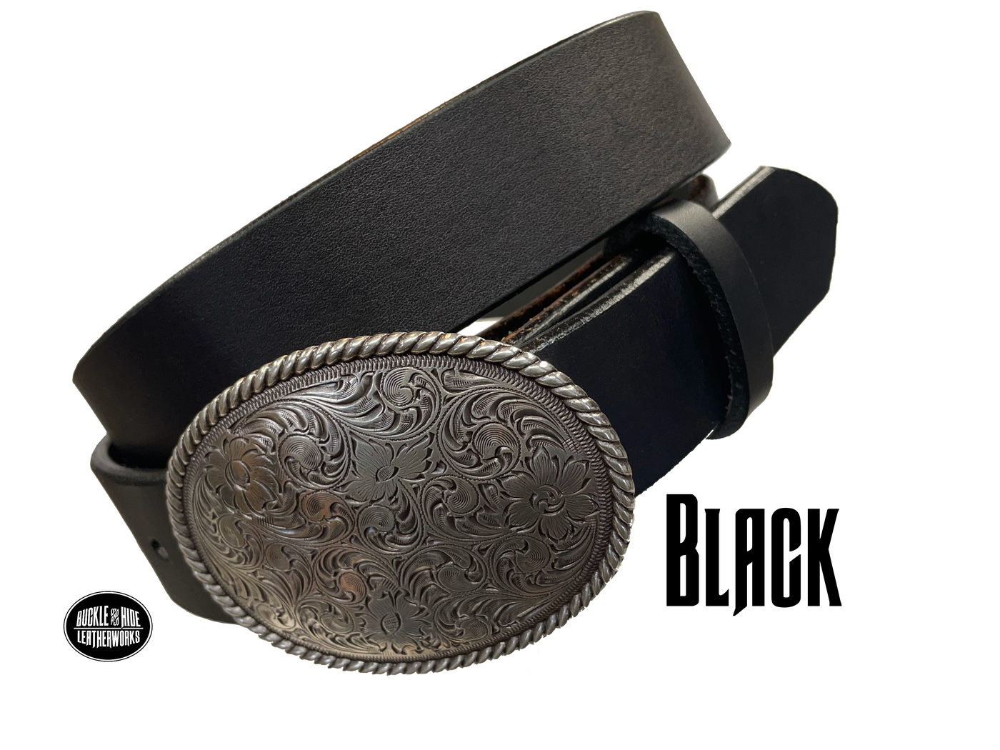 This oval shaped buckle by Nocona has a rope design around the border. It is chrome colored with scroll design etched appearance on surface.  Measures 2 3/4" tall by 3 3/4" wide and fits belts up to 1 1/2" wide. Buckle is made in Taiwan. Belt is a solid strip of leather and made in our shop in Smyrna, TN, just outside Nashville. It is 1 1/2" wide and available in sizes 34"-44" and colors distressed brown, black, and dark brown. It is available for purchase in our retail shop and online store. Black.