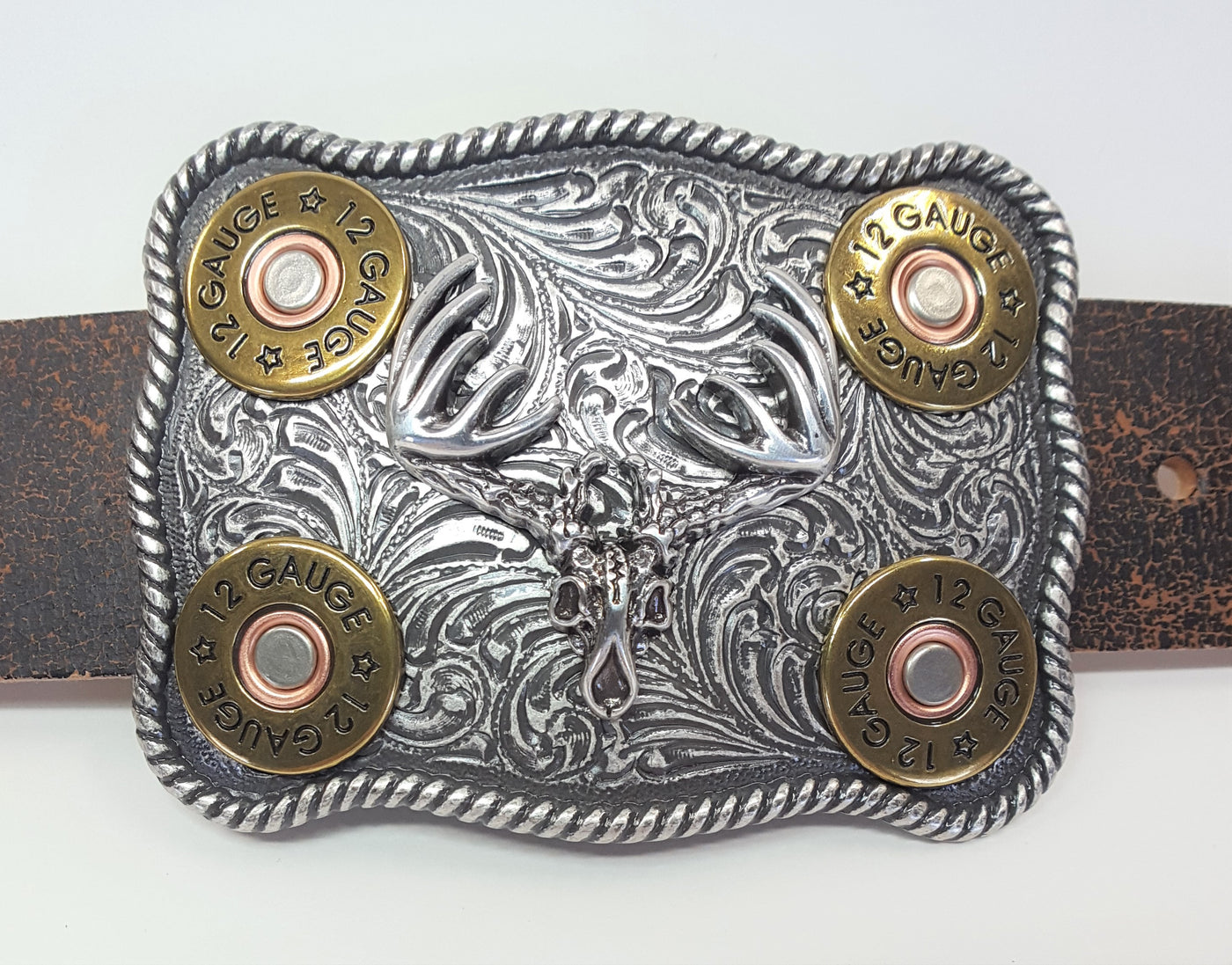 Nocona Western buckle  Smooth edge oval shaped buckle centered with a flying eagle and floral scroll on either side of it. Measures: 3" tall X 4" wide Available online and in our shop in Smyrna, TN, just outside of Nashville