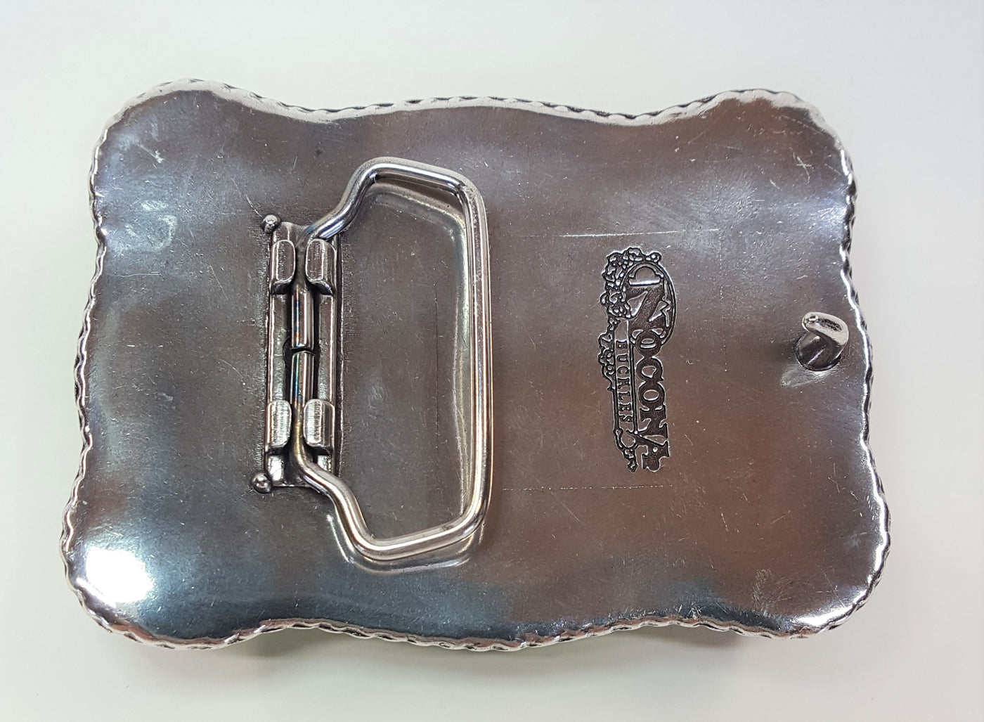 Nocona Western buckle with longhorn steer design Dimensions 2 3/4" tall by 3 3/4" wide Great for accentuating the Western look of your wardrobe Available online and in our shop in Smyrna, TN, just outside of Nashville. back of buckle pictured