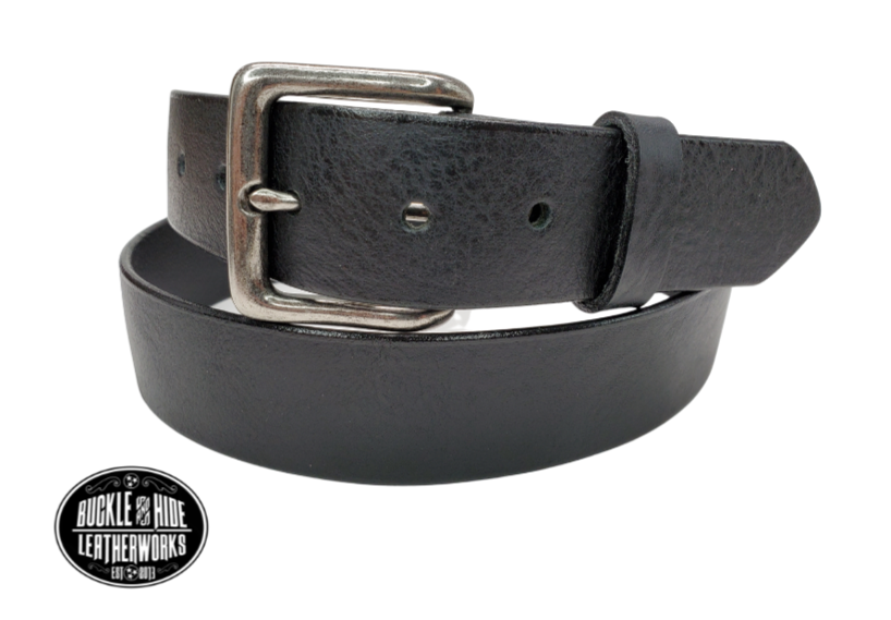 This solid strip of black, soft, Lightly Pebbled top grain  cowhide leather will not tear nor peel apart. It has a classic satin finish, smooth pebble texture, with beveled painted edges. The strap is 1 1/2" wide, approximately 1/8" thick, in sizes from 34" to 44" from buckle end to hole most worn.  It has a antique silver colored buckle. Comfortable from the start, belt is handmade in our Smyrna, TN shop, just outside Nashville.