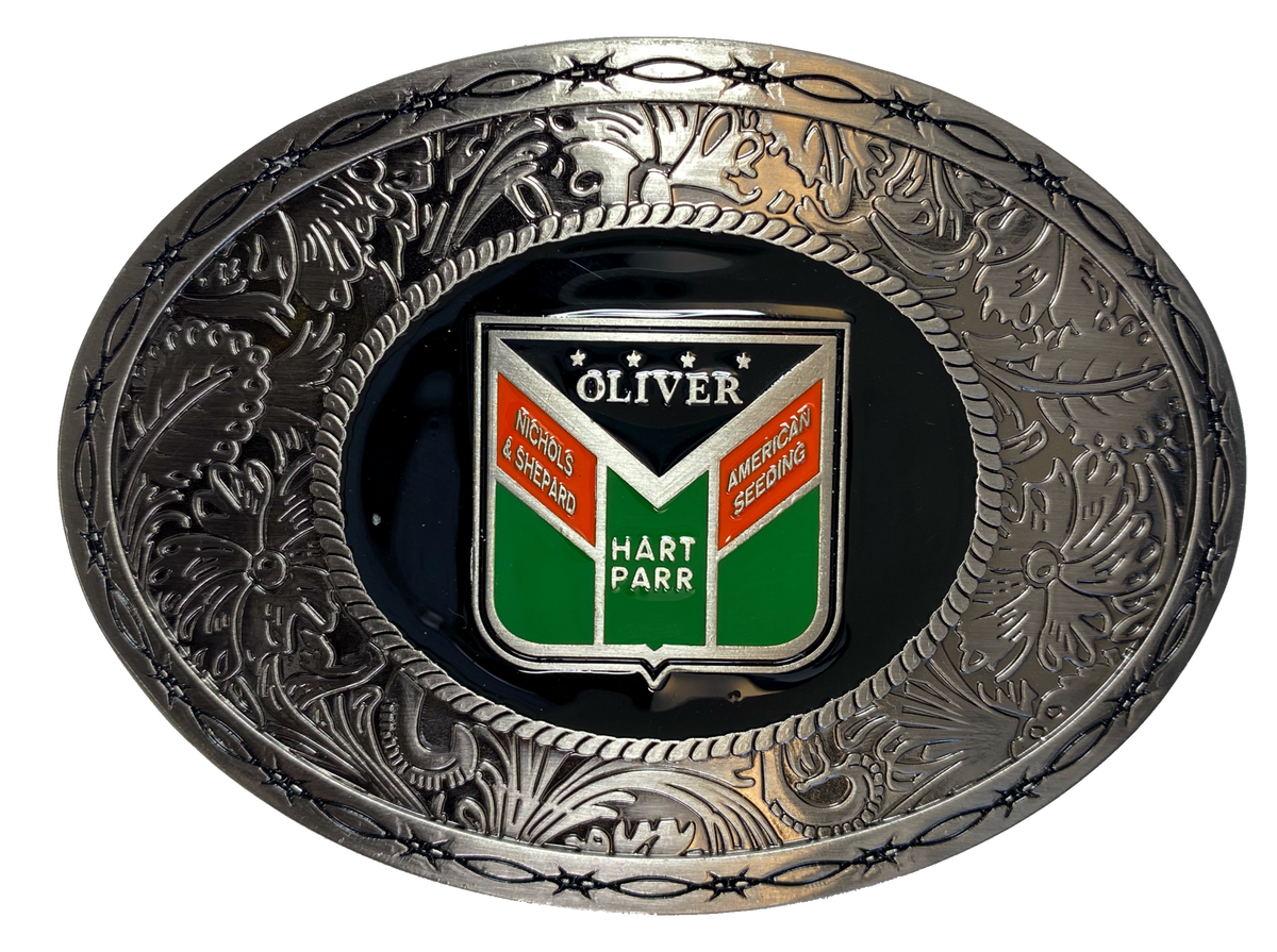 Western influenced oval buckle with barbed wire and western tooling and Oliver Tractor logo in the center. Available online and in our shop just outside Nashville in Smyrna, TN. Approx. 3"x4" in size.