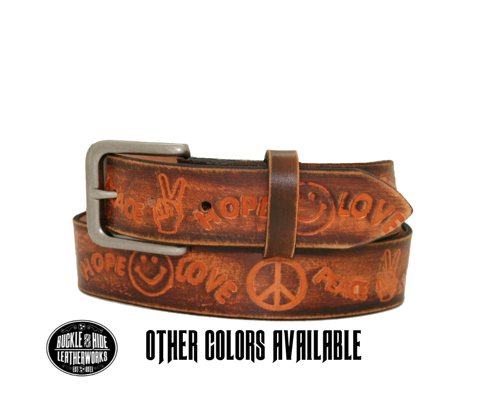Made in our Smyrna, TN, USA shop Hand dyed and distressed brown USA veg-tan cowhide approx. 1/8" thick Embossed with Peace Hope Love design Antique Silver finish buckle snaps in place for easy changing if desired Belt looks worn, hand finished distressed look-new leather will soften with use (like a pair of quality leather boots) Full grain American vegetable tanned cowhide Width 1 1/2" Available in sizes 34" to 46".