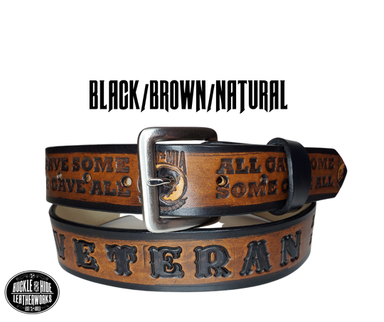 "The Veteran" is a handmade real leather belt made from a single strip of cowhide shoulder leather that is 8-10 oz. or approx. 1/8" thick. It has hand burnished (smoothed) edges and features a POW-MIA emblem along with "SOME GAVE ALL- ALL GAVE SOME pattern down the center. This belt is completely HAND dyed with a multi step finishing technic. The antique nickel plated solid brass buckle is snapped in place with heavy snaps.  This belt is made just outside Nashville in Smyrna, TN.