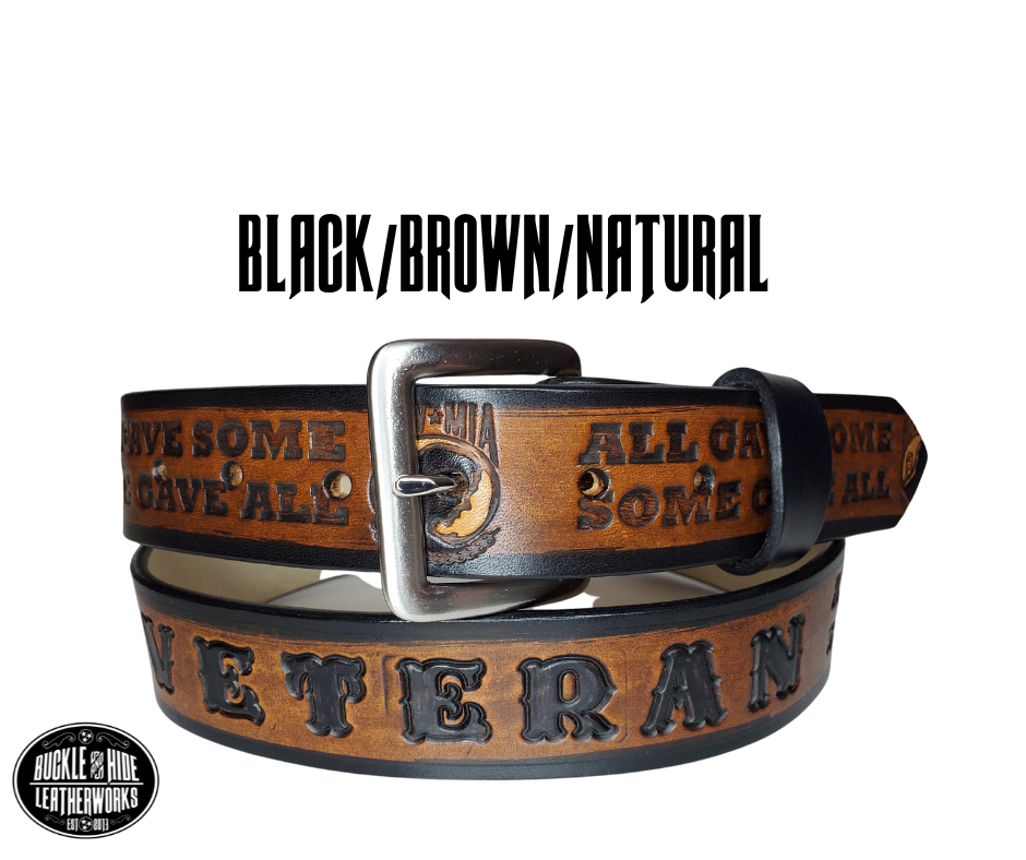 "The Veteran" is a handmade real leather belt made from a single strip of cowhide shoulder leather that is 8-10 oz. or approx. 1/8" thick. It has hand burnished (smoothed) edges and features a POW-MIA emblem along with "SOME GAVE ALL- ALL GAVE SOME pattern down the center. This belt is completely HAND dyed with a multi step finishing technic. The antique nickel plated solid brass buckle is snapped in place with heavy snaps.  This belt is made just outside Nashville in Smyrna, TN.