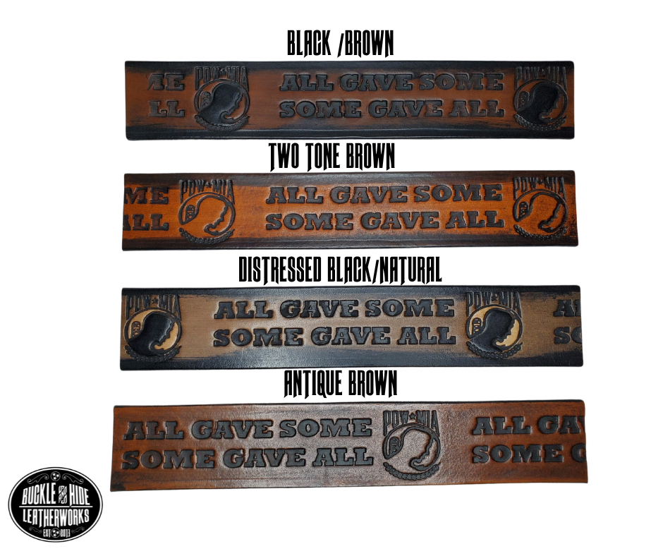 "The Veteran" is a handmade real leather belt made from a single strip of cowhide shoulder leather that is 8-10 oz. or approx. 1/8" thick. It has hand burnished (smoothed) edges and features a POW-MIA emblem along with "SOME GAVE ALL- ALL GAVE SOME pattern down the center. This belt is completely HAND dyed with a multi step finishing technic. The antique nickel plated solid brass buckle is snapped in place with heavy snaps.  This belt is made just outside Nashville in Smyrna, TN.