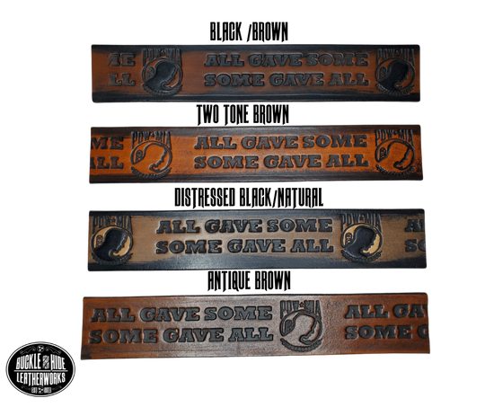 "The Veteran" is a handmade real leather belt made from a single strip of cowhide shoulder leather that is 8-10 oz. or approx. 1/8" thick. It has hand burnished (smoothed) edges and features a POW-MIA emblem along with "SOME GAVE ALL- ALL GAVE SOME pattern down the center. This belt is completely HAND dyed with a multi step finishing technic. The antique nickel plated solid brass buckle is snapped in place with heavy snaps.  This belt is made just outside Nashville in Smyrna, TN.