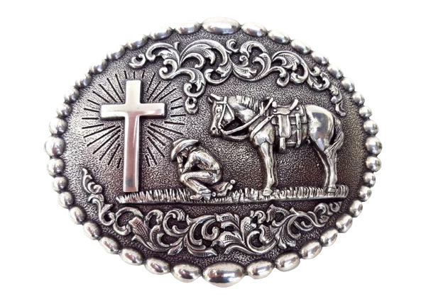 Nocona buckle with beaded edge. Cowboy kneeling at Cross with his trusted horse behind him. A raised floral design perfectly complements this reverent design. Measures 3-1/8" tall by 4" wide  Available online and in our shop in Smyrna, TN, just outside of Nashville