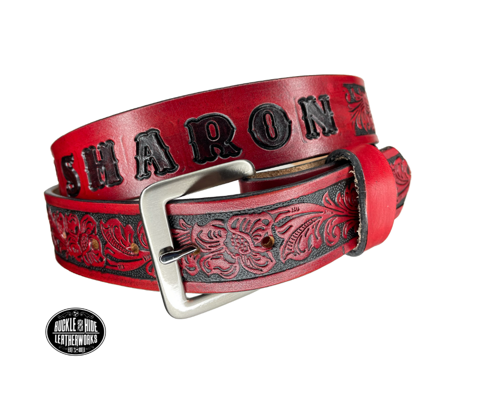 Vegetable tanned cowhide approx. 1/8"thick. Width 1 1/2" and includes Antique Nickle plated Solid Brass buckle Hand dyed BACKGROUND and finished in a TRI TONE FINISH, a multistep process which is where the DELUXE name comes from. Smooth hand burnished painted edges Choose with or without name, if without name, design will cover entire length of belt For name Type name desired on belt in "Type Name Here" section, no more than 8 letters maximum  Made in our Smyrna, TN, USA shop