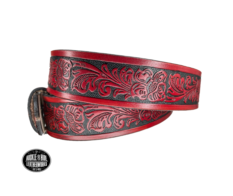 Vegetable tanned cowhide approx. 1/8"thick. Width 1 1/2" and includes Antique Nickle plated Solid Brass buckle Hand dyed BACKGROUND and finished in a TRI TONE FINISH, a multistep process which is where the DELUXE name comes from. Smooth hand burnished painted edges Choose with or without name, if without name, design will cover entire length of belt For name Type name desired on belt in "Type Name Here" section, no more than 8 letters maximum  Made in our Smyrna, TN, USA shop