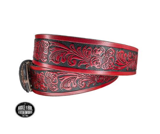 Vegetable tanned cowhide approx. 1/8"thick. Width 1 1/2" and includes Antique Nickle plated Solid Brass buckle Hand dyed BACKGROUND and finished in a TRI TONE FINISH, a multistep process which is where the DELUXE name comes from. Smooth hand burnished painted edges Choose with or without name, if without name, design will cover entire length of belt For name Type name desired on belt in "Type Name Here" section, no more than 8 letters maximum  Made in our Smyrna, TN, USA shop