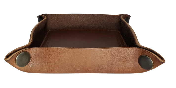 Make it PERSONAL! This handmade real leather valet tray can be personalized with up to 8-10 letters. It has Antique Brass SNAPPED corners to FLATTEN out for easy packing for travel. It is made in our Smyrna, TN shop just outside Nashville. It is a perfect catch-all for keeping keys and other small items in one place at the end of a long day. Makes a great gift for groomsmen, or that special someone.

Med. Approx. 7"x 7" (snapped)
Small Approx. 4.5"x 4.5" (snapped)