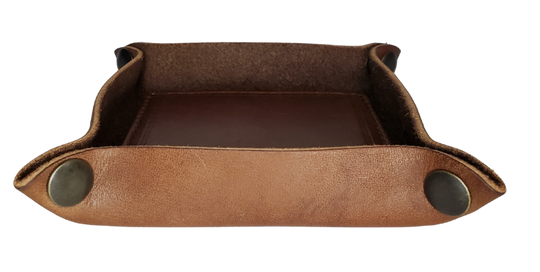 Make it PERSONAL! This handmade real leather valet tray can be personalized with up to 8-10 letters. It has Antique Brass SNAPPED corners to FLATTEN out for easy packing for travel. It is made in our Smyrna, TN shop just outside Nashville. It is a perfect catch-all for keeping keys and other small items in one place at the end of a long day. Makes a great gift for groomsmen, or that special someone.

Med. Approx. 7"x 7" (snapped)
Small Approx. 4.5"x 4.5" (snapped)