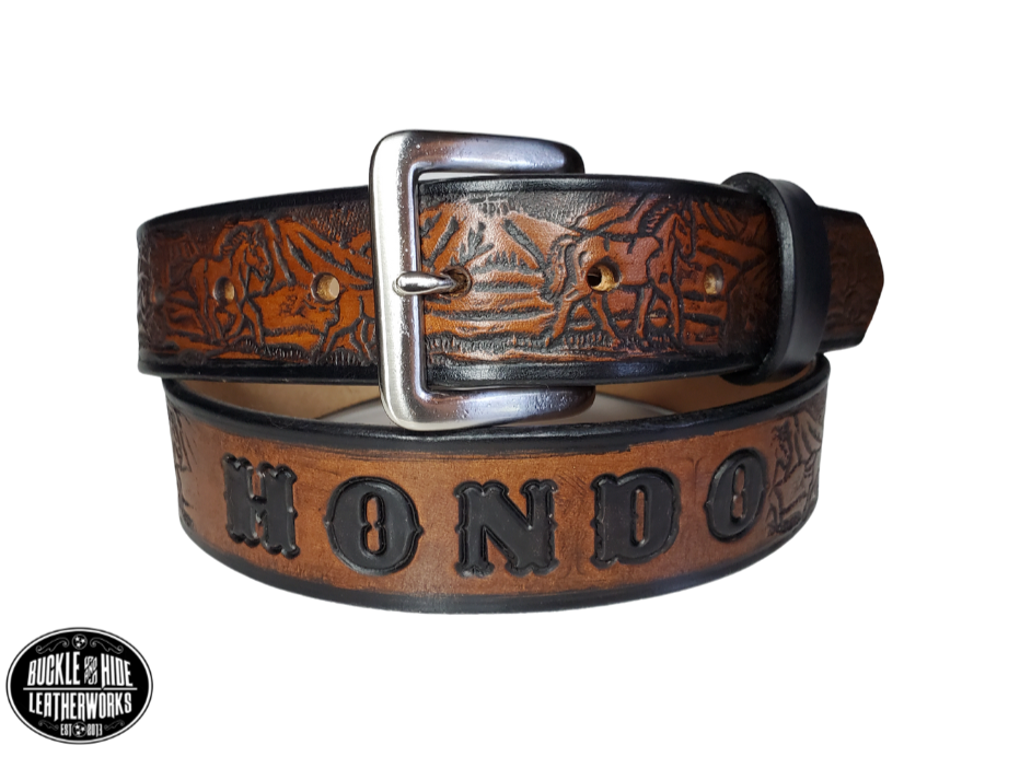 "The Stallion" is a handmade real leather belt made from a single strip of cowhide shoulder leather that is 8-10 oz. or approx. 1/8" thick. It has hand burnished (smoothed) edges and a Wild Horse scene embossed pattern down the center. This belt is completely HAND dyed with a multi step finishing technic. The antique nickel plated solid brass buckle is snapped in place with heavy snaps.  This belt is made just outside Nashville in Smyrna, TN.