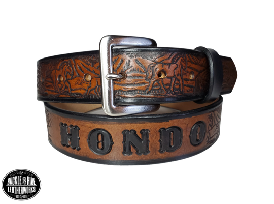 "The Stallion" is a handmade real leather belt made from a single strip of cowhide shoulder leather that is 8-10 oz. or approx. 1/8" thick. It has hand burnished (smoothed) edges and a Wild Horse scene embossed pattern down the center. This belt is completely HAND dyed with a multi step finishing technic. The antique nickel plated solid brass buckle is snapped in place with heavy snaps.  This belt is made just outside Nashville in Smyrna, TN.