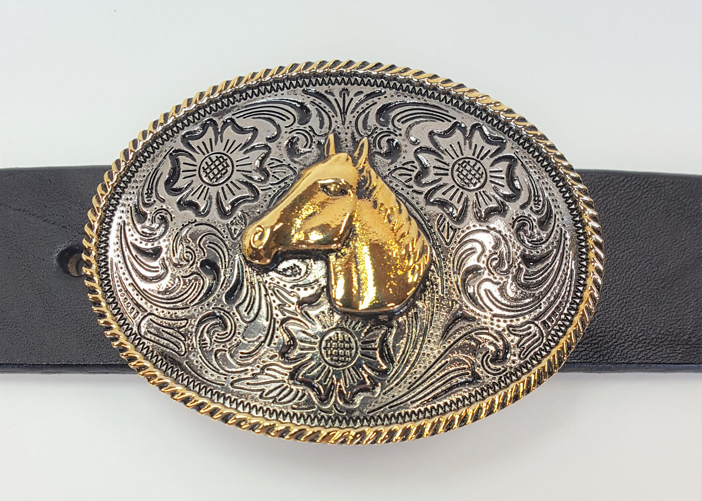 Horsehead buckle by AndWest pictures a chrome colored background with Western scroll and flowered pattern.  Edge of the oval buckle has gold colored rope pattern along the edge and horse head is gold colored and centered on buckle. Works great for child's belt or adult who wants a smaller buckle Fits belt widths up to 1 1/4" Dimensions are 2 3/8" tall by 3 1/4" wide Available in our online store and also in the retail shop in Smyrna, TN, just outside of Nashville. Pictured on black leather belt.