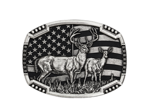 An antiqued silver tone cast buckle with a male and female pair of deer figures standing at attention in the midst of a grassy field. The stars-n-stripes serve as a patriotic backdrop to the animals. The buckle is finished with a smooth wire notched edge with the notches filled with beads. Standard 1.5 inch belt swivel.
