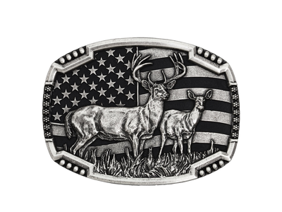 An antiqued silver tone cast buckle with a male and female pair of deer figures standing at attention in the midst of a grassy field. The stars-n-stripes serve as a patriotic backdrop to the animals. The buckle is finished with a smooth wire notched edge with the notches filled with beads. Standard 1.5 inch belt swivel.