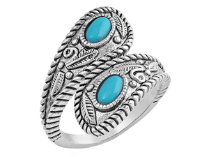 Open ring that is antiqued-silver in color and wraps around the finger to overlap. The twists and curls of the silver are accented by etched florals and filigree. The ends are teardrop in shape and hold a turquoise stone in the middle. Stone color and shape may vary. Rhodium over a sterling silver base. Synthetic turquoise. Available online or at our shop just outside Nashville in Smyrna, TN. 