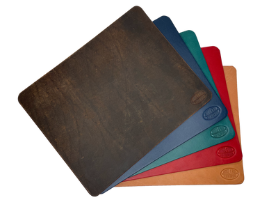 This heavy Bridle leather mouse pad with hand burnished smooth edges and is approx. 1/8" thick. Size is 8" x 10".  This size gives you plenty of room to mouse around! May choose plain or with 1-3 initials stamped in lower left corner with our logo stamped in the lower right corner. Made in our shop just outside Nashville in Smyrna, TN.
