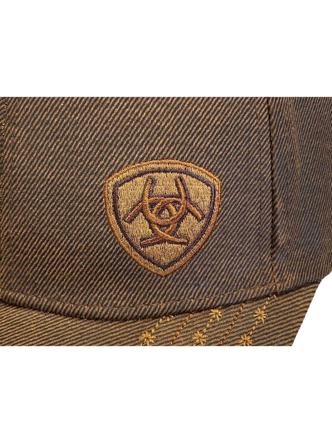 Brown Trucker cap with velcro closure. Structured front has small Ariat logo embroidered. Available at our shop just outside Nashville in Smyrna, TN. Close up of logo pictured.