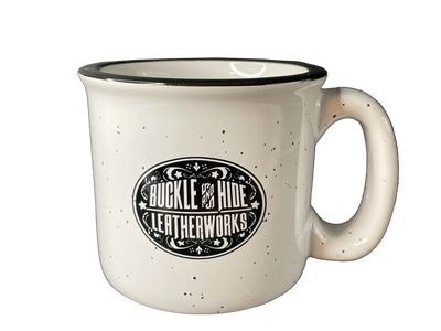 Enjoy for favorite coffee brew in this camping outdoorsy style cup. Our white ceramic mug has a speckled look that lends a rustic appeal that's so a part of our Buckle and Hide Shop. Available in our shop just outside Nashville in Smyrna, TN. 