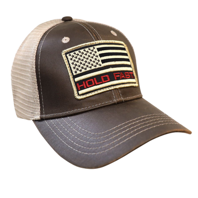 Hold fast to faith, family, and freedom in this rugged “Flag Red & Tan” Cap in Brown/Tan by HOLD FAST®. Hold fast to your faith, your family, and your freedom. We can celebrate these things because of the sacrifice of those who serve in the United States Armed Forces, and ultimately because of the sacrifice of our Lord and Savior, Jesus Christ, on the cross at Calvary.  Available online or in our shop just outside Nashville in Smyrna, TN.