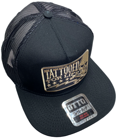 Flat Bill Cap with mesh back. Front has a Gold embroidered patch that says "Tattooed for Life" and has a skull graphic. Structured top to keep its shape. Sold at our shop just outside Nashville in Smyrna, TN.