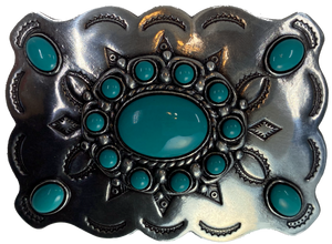 Southwestern style belt buckle with Southwestern tooling, scalloped design around edges, and simulated turquoise stones, approx. size 3 1/2" wide by 2 1/2" tall.  Color is antique silver, buckle is made of zinc. Fits belts 1 1/2" wide. Available online and in our shop just outside Nashville in Smyrna, TN.