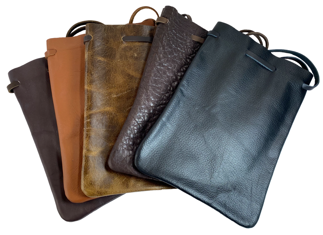 Leather pouch with drawstring. Available in Black and Assorted Brown. Fill it with anything you like, a camera, your rock collection, tools etc. This large leather pouch can be used to hold a small canteen or flask. Made in USA.