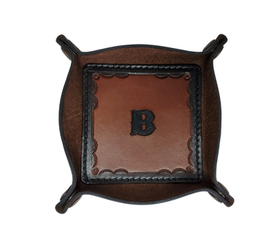 This Valet is different than our Gulch tray because of the HAND SATAMPED border design with Hand Finishing done on the VEG -TAN inside. Antique Brass SNAPPED corners to FLATTEN out for easy packing for travel. It is made in our Smyrna, TN shop just outside Nashville.  The Stitched inside leather matches the outside for rustic look. It is a perfect catch-all for keeping keys and other small items in one place at the end of a long day.  Makes a great gift for groomsmen, or that special someone.