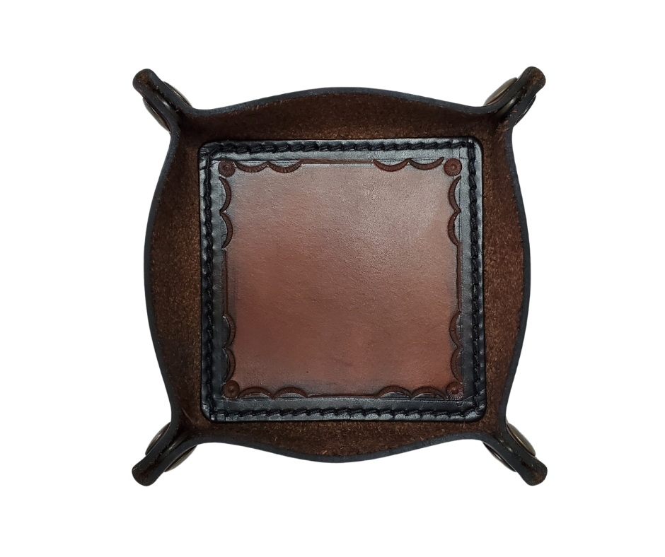 This Valet is different than our Gulch tray because of the HAND SATAMPED border design with Hand Finishing done on the VEG -TAN inside. Antique Brass SNAPPED corners to FLATTEN out for easy packing for travel. It is made in our Smyrna, TN shop just outside Nashville.  The Stitched inside leather matches the outside for rustic look. It is a perfect catch-all for keeping keys and other small items in one place at the end of a long day.  Makes a great gift for groomsmen, or that special someone.
