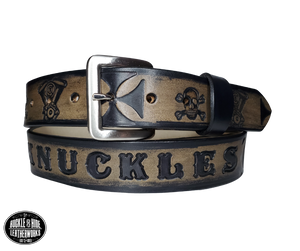"The Hardtail" is a handmade real leather belt made from a single strip of cowhide shoulder leather that is 8-10 oz. or approx. 1/8" thick. It has hand burnished (smoothed) edges and features a V-twin engine, Skull and Crossbones and Maltese style cross pattern down the center. This belt is completely HAND dyed with a multi step finishing technic. The antique nickel plated solid brass buckle is snapped in place with heavy snaps.  This belt is made just outside Nashville in Smyrna, TN.