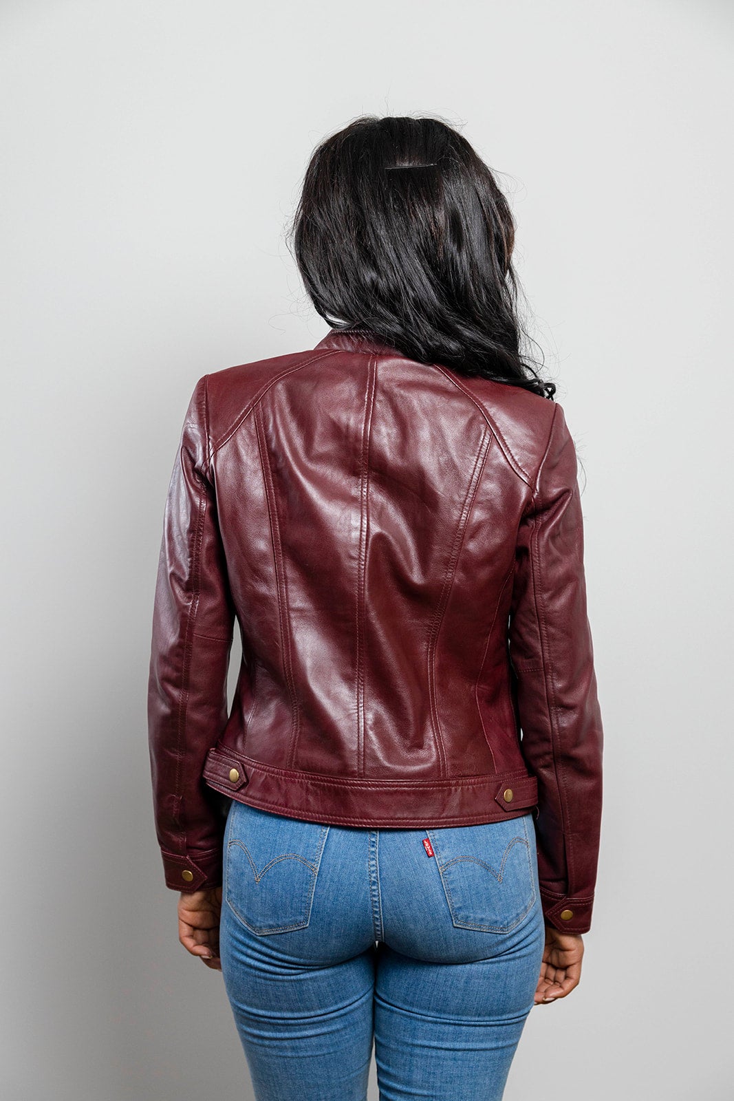 This classic cut genuine leather jacket is perfect for any occasion, from the Whet Blu line.  Dyed Leather. Zipper front. Long sleeves with adjustable snap cuffs. Wind resistant shell. Three outside pockets. Two inside pockets. Designed to hit just below the waist. Lightweight. Lining is polyester. dry clean. Imported. Available in sizes XS-5X, online only. Colors: army green, night blue, whiskey, black and oxblood. Back lifestyle view