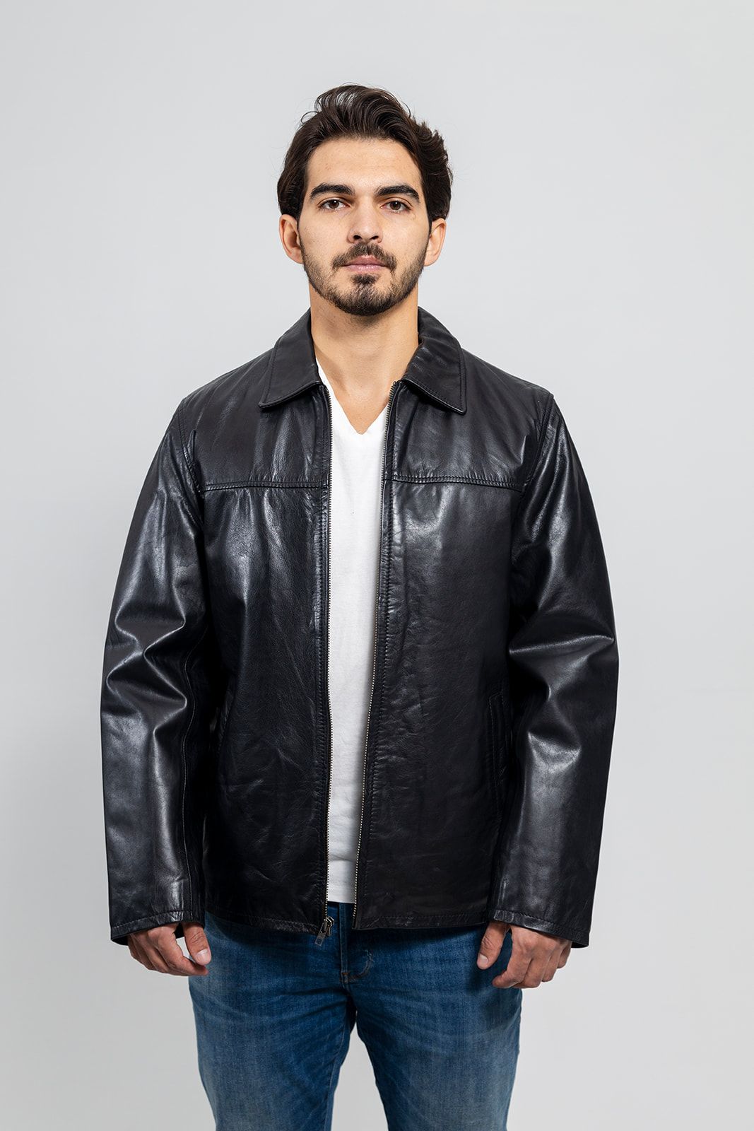 This fashion leather men's jacket from Whet Blu is a wardrobe staple. A sleek and simple zipped blazer with folded collar perfect for a casual day or an evening out. Naked cowhide leather. Classic fit. Full zip out liner. Two hand pockets. Clean by leather specialist. Lifetime Warranty on Hardware. Available in black and whiskey. Sizes S-5X. Online only. lifestyle front view