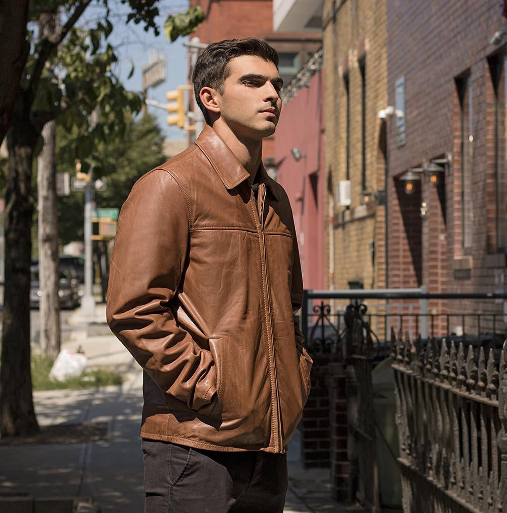 This fashion leather men's jacket from Whet Blu is a wardrobe staple. A sleek and simple zipped blazer with folded collar perfect for a casual day or an evening out. Naked cowhide leather. Classic fit. Full zip out liner. Two hand pockets. Clean by leather specialist. Lifetime Warranty on Hardware. Available in black and whiskey. Sizes S-5X. Online only. lifestyle side view