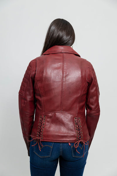 A classic rocker style jacket made from lambskin leather from Whet Blu.  Classic fit. Zip sleeves. Fully lined. One chest pocket. Two hand pockets. Lifetime Warranty on Hardware. Clean by leather specialist. Imported. Available in Black and Oxblood. Sizes XS-5X. Online Only, back of jacket, lifestyle picture