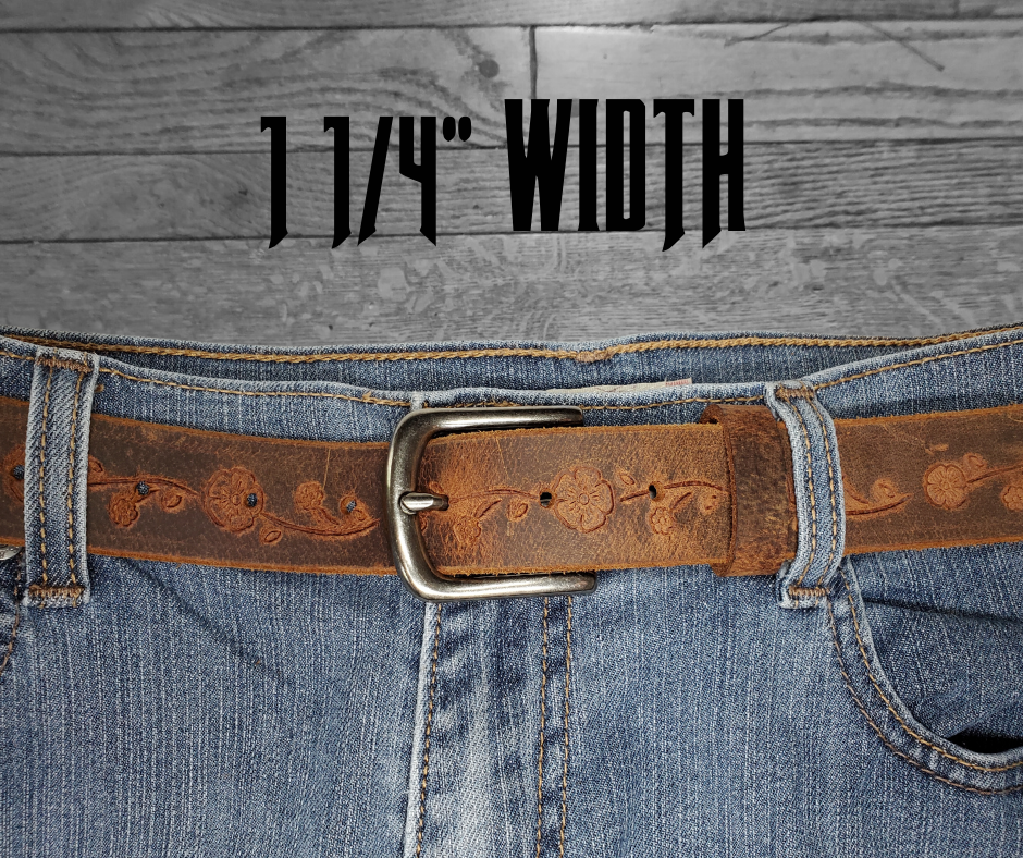 This brown leather belt is made from Crazy Horse tanned leather for that distressed and pull-up look. We embossed a flower vine down the center just give that feminine touch. The edges are beveled and left raw for a contrasting look. It has an antique nickel coated solid brass buckle that is snapped in place. Belt is 1 1/4" wide and available in lengths from 34" to 44".  It is handmade in our shop in Smyrna, TN, just outside of Nashville.
