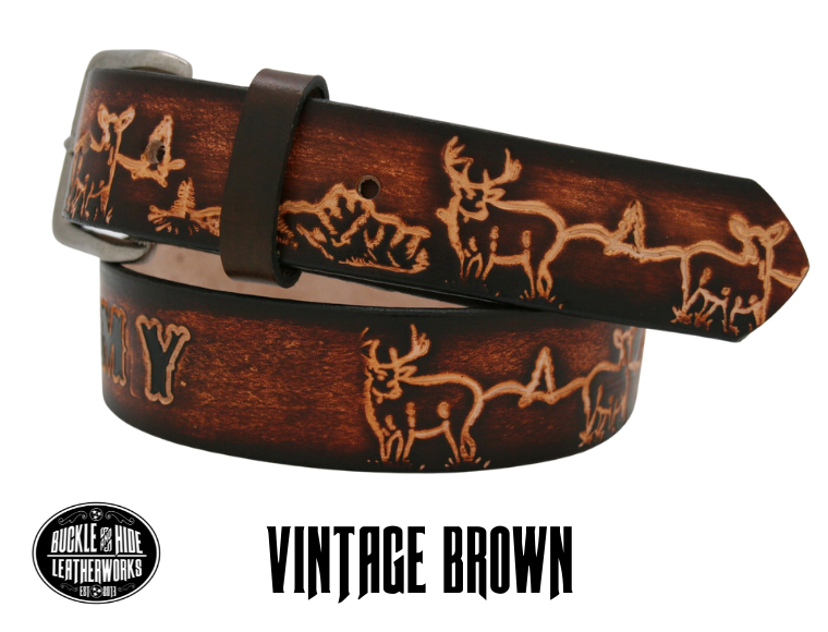 This belt is for the Outdoorsy type with Deer scene embossed onto a solid strip of Veg Tan cowhide, is hand stained brown, with smooth, finished edges. Embossed with a classic deer scene down length of belt, or have name added to scene up to 10 letters. Belt thickness is approx. 1/8", and 1 1/2" wide. Attached with 2 snaps, for easy buckle change, is an antique silver colored buckle. Made just outside Nashville in our Smyrna TN shop.