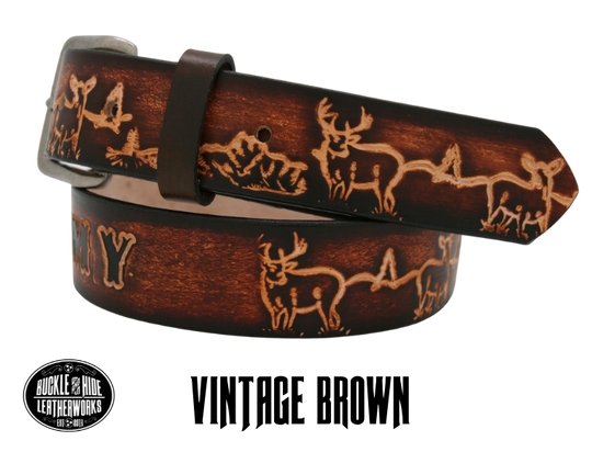 This belt is for the Outdoorsy type with Deer scene embossed onto a solid strip of Veg Tan cowhide, is hand stained brown, with smooth, finished edges. Embossed with a classic deer scene down length of belt, or have name added to scene up to 10 letters. Belt thickness is approx. 1/8", and 1 1/2" wide. Attached with 2 snaps, for easy buckle change, is an antique silver colored buckle. Made just outside Nashville in our Smyrna TN shop.