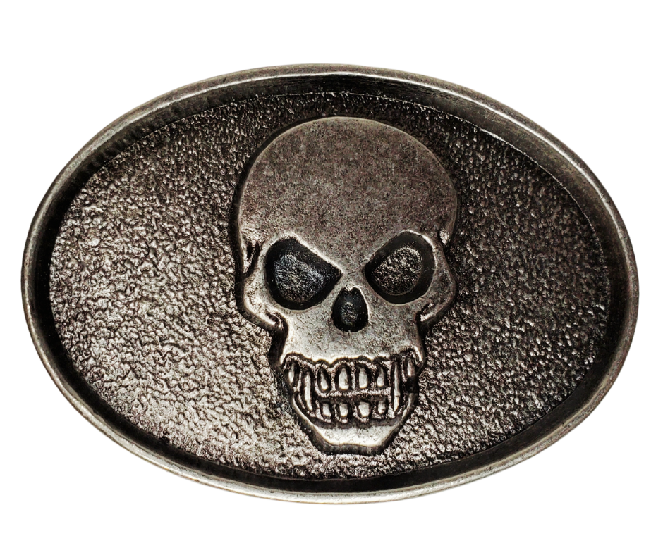 The Biker Skull Belt Buckle is an antique silver design that is sure to add a unique touch to any accessory. Crafted with a detailed skull head, this buckle is perfect for those looking for an edgy yet stylish addition to their wardrobe.  Pewter belt buckle that may be attached to your belt.  It has a oval shape that Fits 1 1/2" belts, Size approx. 3-1/2" x 2-3/4. Available in our shop just outside Nashville in Smyrna, TN.