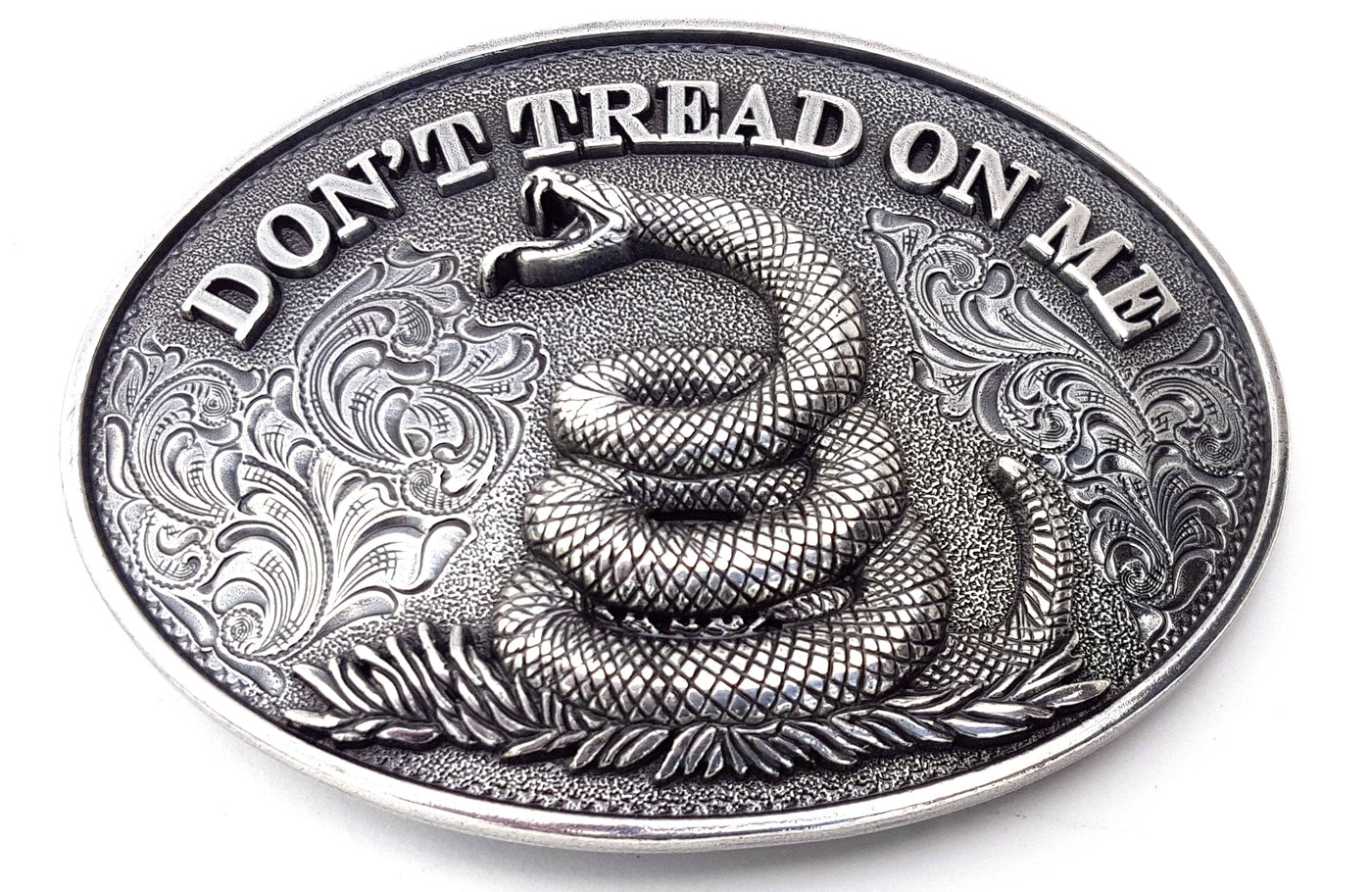 Oval shaped Nocona buckle Smooth edge and "Don't Tread On Me" motif Measures 2 1/2" tall by 3 1/2" wide Made in Taiwan Available online and in our shop in Smyrna, TN, just outside of Nashville