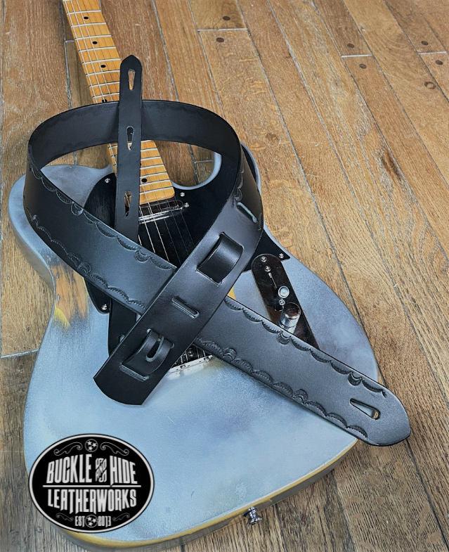 We dressed this up just a bit with a Border design versus "the CASH". It's made from 1/8" thick drum dyed vegetable tanned cow hide and has a smooth, glossy finish.  The main strap is made from a single strip of leather with beveled and painted edges.  Choose a 2" or 2 1/2" wide strap with a classic adjustment style. Made just outside Nashville in Smyrna, TN.