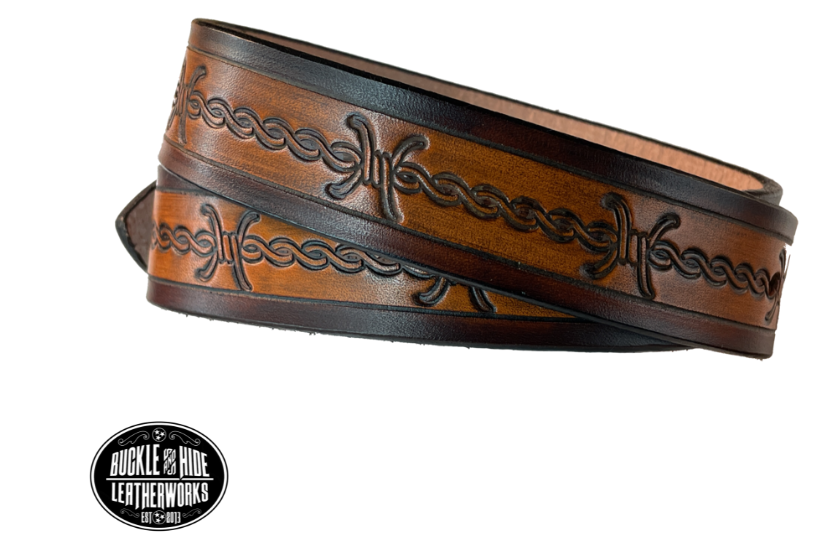 Our "Kid's Barbwire" is just like the Riding Fence' for dad or mom. Full grain American vegetable tanned cowhide approx. 1/8"thick. Width is 1 1/4" and includes Antique Nickle plated Solid Brass buckle. We Hand Finish with each belt. Edges are smooth burnished painted edges. Made in our Smyrna, TN, USA shop. Buckle snaps in place for easy changing if desired. Choose with or without name, if without name, design will cover entire length of belt.