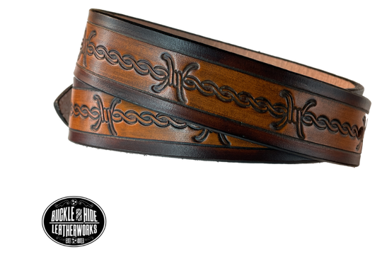 Our "Kid's Barbwire" is just like the Riding Fence' for dad or mom. Full grain American vegetable tanned cowhide approx. 1/8"thick. Width is 1 1/4" and includes Antique Nickle plated Solid Brass buckle. We Hand Finish with each belt. Edges are smooth burnished painted edges. Made in our Smyrna, TN, USA shop. Buckle snaps in place for easy changing if desired. Choose with or without name, if without name, design will cover entire length of belt.