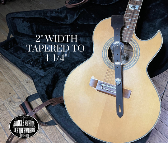 You don't get more classic than a handcrafted Distressed leather guitar strap! Featuring a ornate 3 piece western buckle set in the front position of the strap. Each size of buckle set is similar but not the same, so check out pictures. It's made from 1/8" thick drum distressed water buffalo and looks like a vintage "Tele". The main strap is made from a single strip of leather with beveled and .  Choose a 2" or 2 1/2" wide strap with a classic adjustment style.  Made just outside Nashville in Smyrna, TN.
