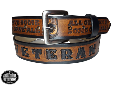 "The Veteran" is a handmade real leather belt made from a single strip of cowhide shoulder leather that is 8-10 oz. or approx. 1/8" thick. It has hand burnished (smoothed) edges and features a POW-MIA emblem along with "SOME GAVE ALL- ALL GAVE SOME pattern down the center. This belt is completely HAND dyed with a multi step finishing technic. The antique nickel plated solid brass buckle is snapped in place with heavy snaps.  This belt is made just outside Nashville in Smyrna, TN.